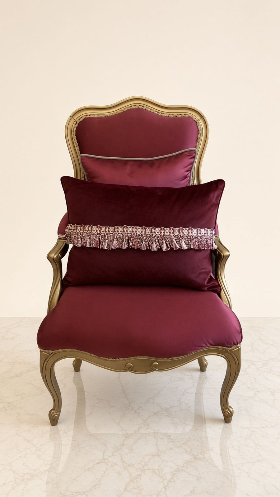 Maison Rouge Armchair in deep crimson satin with antique gold carved frame and tassel cushion