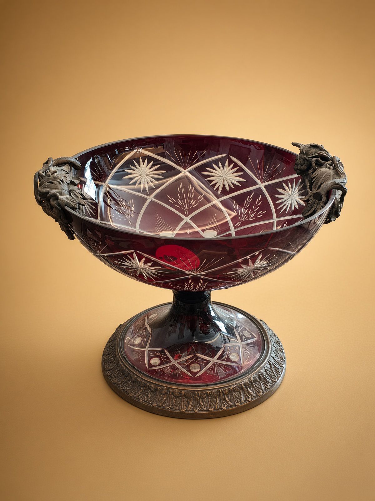 Vintage ruby red hand-cut crystal pedestal bowl with ornate bronze foliage mounts and classical base